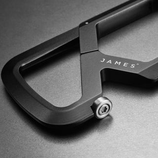 Close-up of black anodized aluminum James The Mehlville Carabiner corner with visible screw and sleek matte finish
