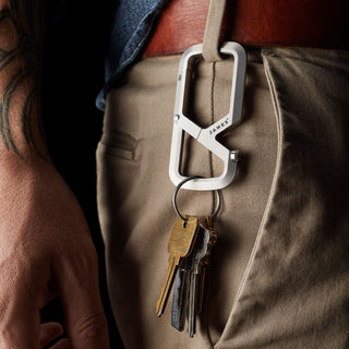 James The Mehlville Carabiner in anodized aluminum clipped to pants holding multiple keys on keyring