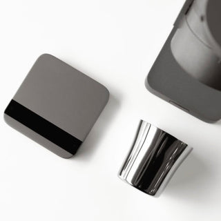 ACAIA Lunar Digital Scale in sleek gray with a reflective stainless steel coffee scoop beside it on white background