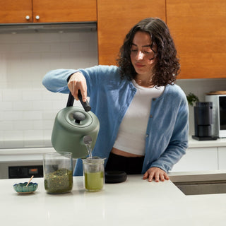 Fellow Clyde Electric Kettle (120V) (1500ml/50oz) pouring hot water from matte green steel kettle