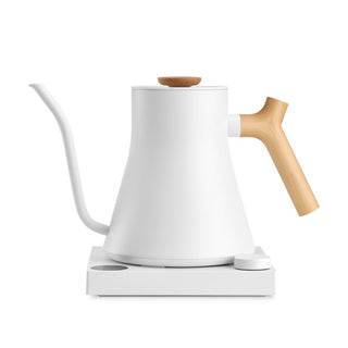 Fellow Stagg EKG Pro Electric Pour Over Kettle (120V) with white body and wooden handle on base