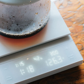 HARIO Polaris Coffee Scale showing precise digital weight and timer with glass container on top
