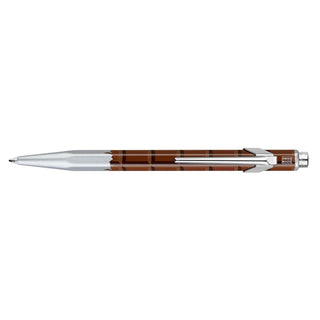 Caran d'Ache 849 Essentially Swiss Ballpoint Pen with brown hexagonal aluminum body and silver tip