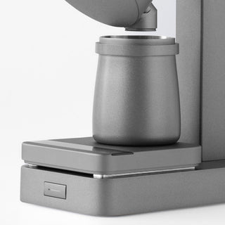 ACAIA Lunar Digital Scale with matte gray surface holds a modern ceramic container under a dispenser arm