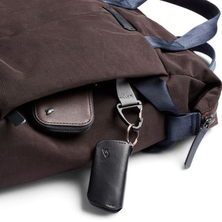 Bellroy Tokyo Totepack Compact in brown with blue straps, showing front pocket and leather key holder attached