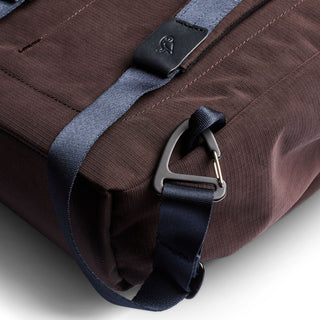 Bellroy Tokyo Totepack Compact in dark fabric with blue strap and metal clip detail close-up