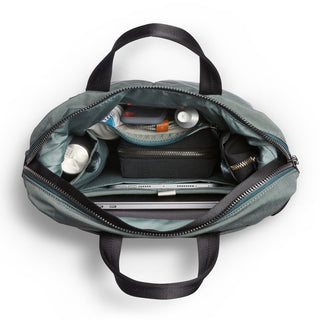 Bellroy Tokyo Totepack Compact in teal showing organized interior with multiple compartments and tech storage pockets