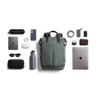 Bellroy Tokyo Totepack Compact in green fabric with tech accessories and travel essentials laid out