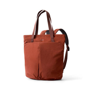 Bellroy Lite Totepack in rust fabric with tote handles and padded backpack straps angled left