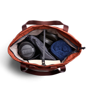 Bellroy Lite Totepack in rust with organized interior holding water bottle and towel