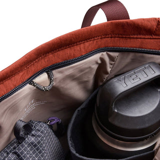 Bellroy Lite Totepack showing rust-colored fabric interior with organized compartments and water bottle pocket