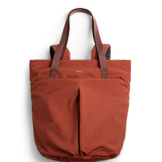 Bellroy Lite Totepack in burnt orange with dual front pockets and brown shoulder straps made from recycled fabric