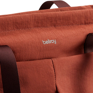 Close-up of rust-colored Bellroy Lite Totepack fabric texture and logo with brown straps visible