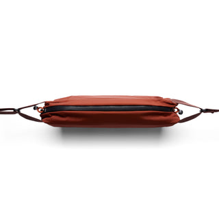 Bellroy Lite Sling in rust color with slim, water-resistant recycled PET fabric and black zipper detail