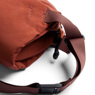 Bellroy Lite Sling in rust color showing durable fabric texture and adjustable strap detail