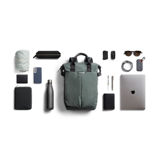 Bellroy Tokyo Totepack in green recycled nylon with organized travel and tech accessories laid out flat