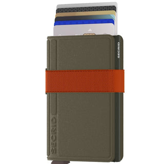 Secrid Bandwallet Liba non-leather wallet in dark green with orange elastic band and multiple cards visible