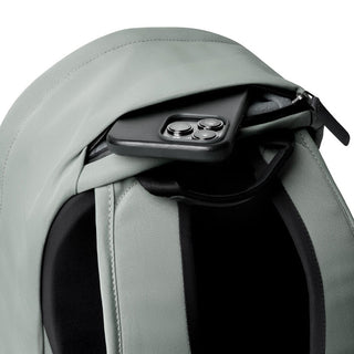 Bellroy Classic Backpack Compact in light gray showing top zipper pocket with smartphone inside
