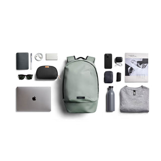 Bellroy Classic Backpack Compact in sage green with smooth recycled fabric and organized daily essentials nearby