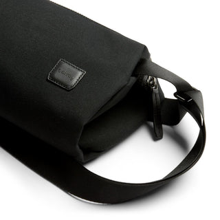 Bellroy Classic Sling 3L in black fabric with leather logo patch and adjustable strap detail