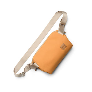 Bellroy Classic Sling 3L in orange with beige adjustable strap and recycled fabric construction