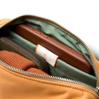 Bellroy Classic Sling 3L showing soft green interior lining and organized storage compartments