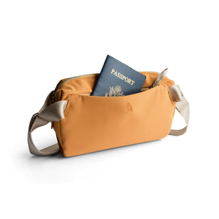 Bellroy Classic Sling 3L in tan with passport partially visible inside front pocket