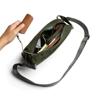 Bellroy Classic Sling 3L in green with multiple compartments and leather key holder attachment