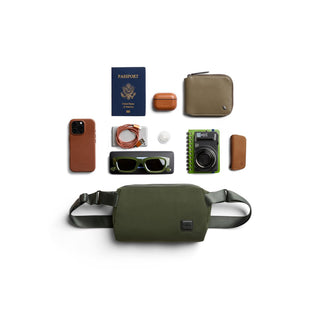 Bellroy Classic Sling 3L in olive green recycled fabric with adjustable straps and laid flat accessories