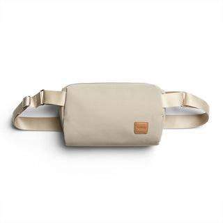 Bellroy Classic Sling 3L in beige with adjustable strap and leather logo patch on front
