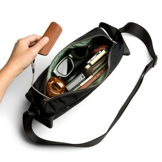 Bellroy Classic Sling 5L in black with organized interior and green fabric lining visible from top view