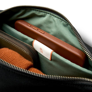 Bellroy Classic Sling 5L showing green recycled fabric lining and organized interior compartments