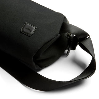 Bellroy Classic Sling 5L in black recycled fabric with leather logo patch and adjustable strap close-up view