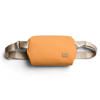 Bellroy Classic Sling 5L in orange with beige adjustable straps made from recycled materials
