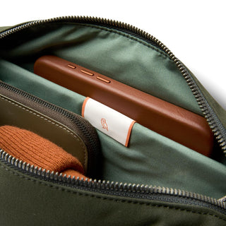 Bellroy Classic Sling 5L showing organized interior with eco-friendly fabric and leather phone case pocket