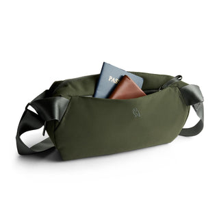 Bellroy Classic Sling 5L in olive green with black strap holding passport and wallet visible