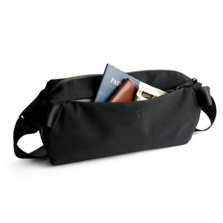 Bellroy Classic Sling 7L black crossbody bag open with travel essentials inside