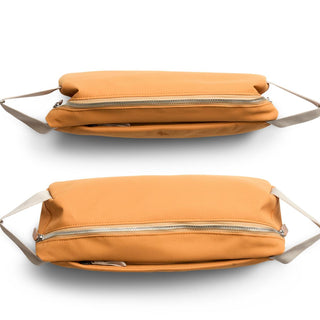 Bellroy Classic Sling 7L in tan recycled fabric showing top zipper and slim profile design