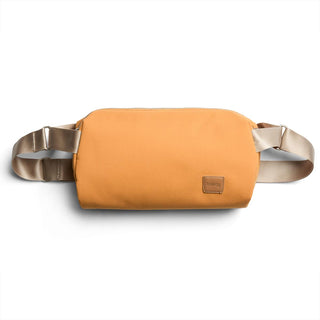 Bellroy Classic Sling 7L in mustard yellow with smooth recycled fabric and adjustable beige straps