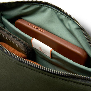 Bellroy Classic Sling 7L interior showing green fabric lining and a leather phone case in pocket