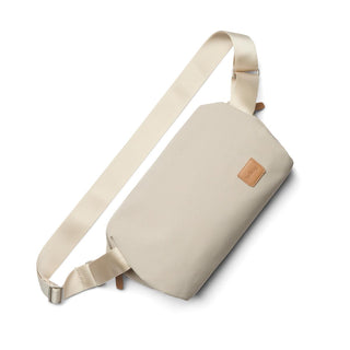 Bellroy Classic Sling 7L in light beige recycled fabric with adjustable strap and leather logo patch