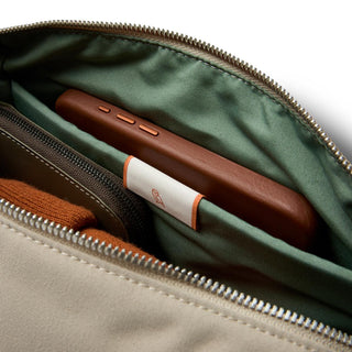 Bellroy Classic Sling 7L inner pocket showing organized storage with soft green recycled fabric lining