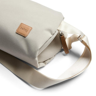 Bellroy Classic Sling 7L in light beige with smooth fabric and leather logo patch on adjustable strap