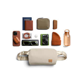 Bellroy Classic Sling 7L in sand color with smooth texture shown with everyday travel essentials