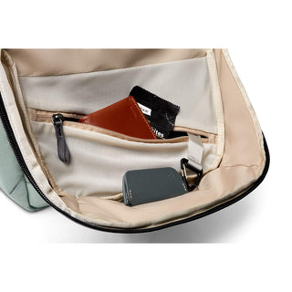 Interior view of Bellroy Via Backpack showing organized cream fabric pockets with wallet and key pouch inside