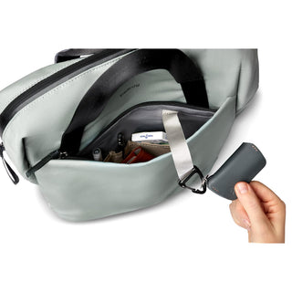 Bellroy Via Workpack open pocket showing organized essentials and key clip in light grey fabric