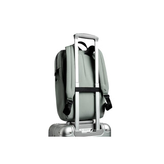 Bellroy Via Workpack in muted green attached to silver suitcase handle with padded straps visible