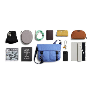 Bellroy Cinch Messenger Bag in soft blue nylon with adjustable strap and front buckle closures