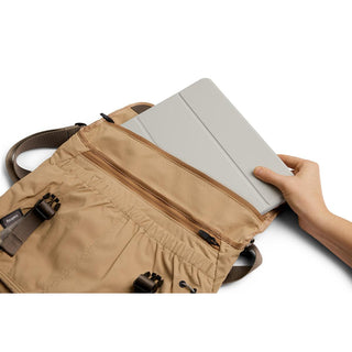 Bellroy Cinch Messenger Bag in tan showing interior pockets with tablet being inserted by hand