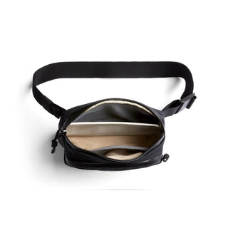 Bellroy Venture Hip Pack 1.5L open black crossbody bag showing organized interior compartments